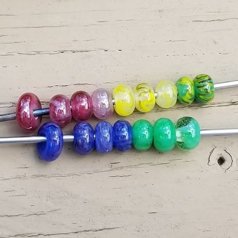 An assortment of beads in red, yellow, blue, and green